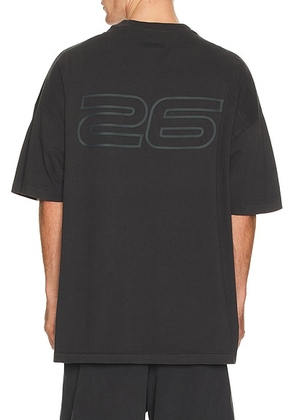 Fear of God ESSENTIALS 90'S Short Sleeve Tee in Vintage Black - Black. Size M (also in XS, S, L, XL/1X, XXL/2X).