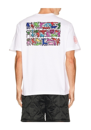 ALPHA INDUSTRIES x Keith Haring Graphic Tee in White. Size L. Also in S, M, XL/1X, XXL/2X.