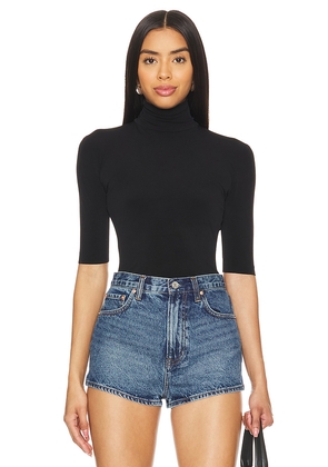 Norma Kamali Slim Fit Short Sleeve Turtleneck Top in Black. Size M. Also in S, XL.