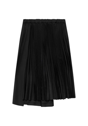 Black Comme Des Garçons asymmetric pleated skirt