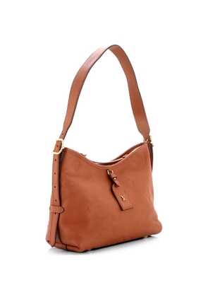 Louis Vuitton Pre-Owned CarryAll Monogram Empreinte Giant PM hobo bag - Brown