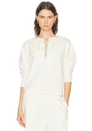 Literary Sport Daphne Lace Up Sweater in Bone - Cream. Size L (also in M, S, XS).