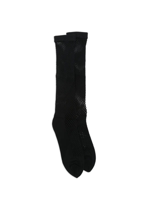 Black Comme Des Garçons fishnet socks