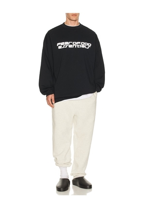 Fear of God ESSENTIALS 90'S Long Sleeve Tee in Black. Size M. Also in XS, S, L, XL/1X, XXL/2X.