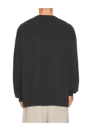 Fear of God ESSENTIALS 90'S Long Sleeve Tee in Black. Size M. Also in L, XL/1X, XXL/2X.