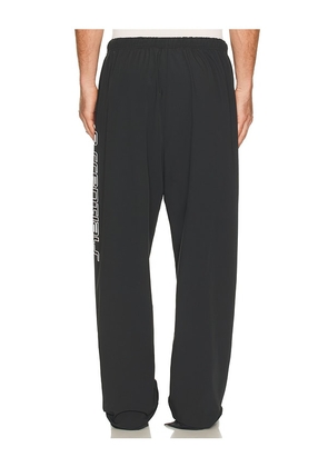 Fear of God ESSENTIALS Relaxed Track Pant in Black. Size M. Also in XS, S, L, XL/1X, XXL/2X.