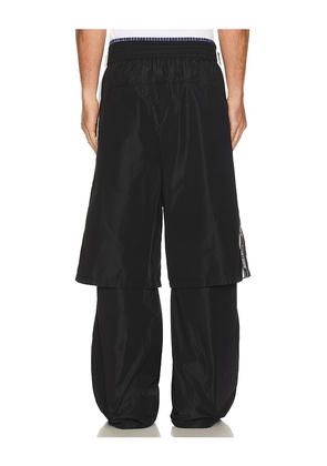 WE11DONE Triple Layered Track Pants in Black. Size M. Also in S, XL/1X.