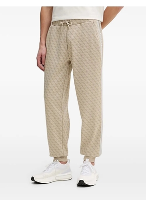 GUESS USA monogram-pattern track pants - Neutrals
