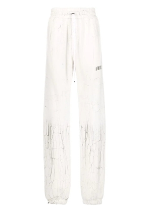 AMIRI cracked-print track pants - White
