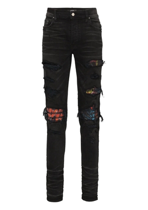AMIRI MX1 patch distressed slim-leg jeans - Black