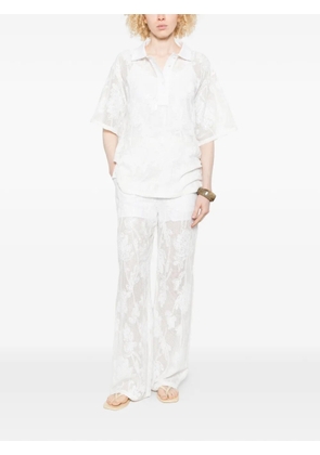 Isabelle Blanche floral-motif trousers - White