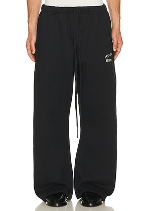Fear of God ESSENTIALS Flare Sweatpant in Vintage Black - Black. Size L (also in M, S, XL/1X, XS, XXL/2X).