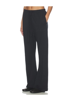 Fear of God ESSENTIALS Signature Classic Fit Flare Sweatpant in Black. Size L. Also in XS, S, M, XL.