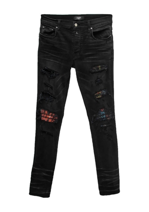 AMIRI distressed-effect patchwork-detail jeans - Black