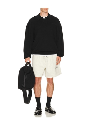 Fear of God ESSENTIALS Signature 90's Knit Polo in Black. Size XS. Also in S, M, L, XL/1X, XXL/2X, XXXL/3X.