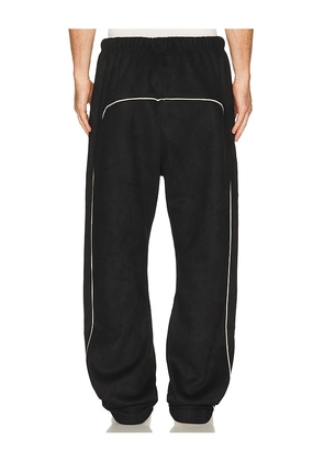 Fear of God ESSENTIALS Signature Relaxed Pant in Black. Size XS. Also in S, M, L, XL/1X, XXL/2X, XXXL/3X.