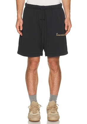Fear of God ESSENTIALS Training Classic Fit Short in Faded Black - Black. Size XS (also in S, M, L, XL/1X, XXL/2X, XXXL/3X).