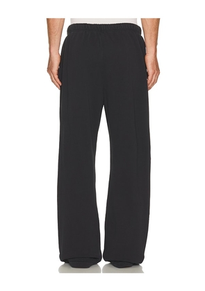 Fear of God ESSENTIALS Training Classic Fit Flare Sweatpant in Black. Size XS. Also in S, M, L, XL/1X, XXL/2X.
