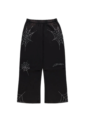 SP5DER rhinestone-embellished spider-web track pants - Black