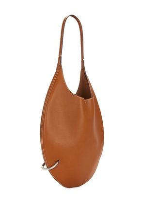 Tory Burch Pierced Soft Bag in Tan.