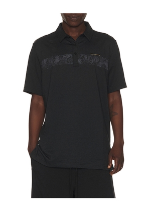 TravisMathew Performance Jersey Flight Polo in Black. Size L. Also in S, M, XL/1X.