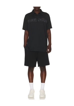 TravisMathew Performance Jersey Flight Polo in Black. Size L. Also in S, M.