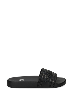 Love Moschino logo-embossed slides - Black