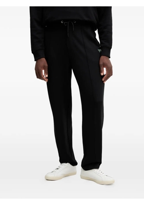 GUESS USA logo-patch drawstring track pants - Black