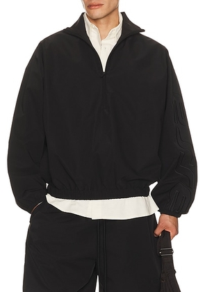 Fear of God ESSENTIALS Active Trace 1/2 Zip Track Jacket in Vintage Black - Black. Size XS (also in S, M, L, XL/1X, XXL/2X).