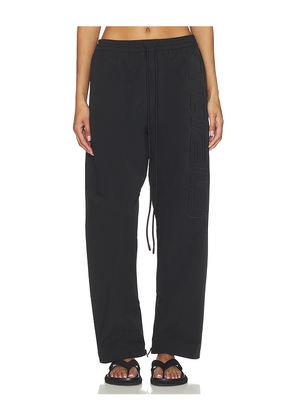 Fear of God ESSENTIALS Active Trace Track Pant in Black. Size M. Also in XS, S, L, XL.