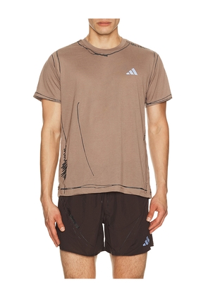 adidas by Song for the Mute Running Tee in Brown. Size XS. Also in S, M, L, XL/1X.