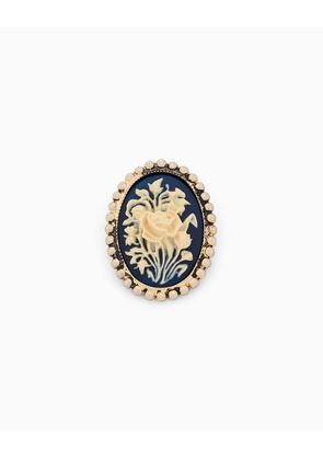 Brass cameo brooch with a floral motif and beaded border