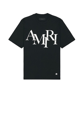 Amiri Staggered Logo Tee in Black - Black. Size L (also in S, M, XL/1X).