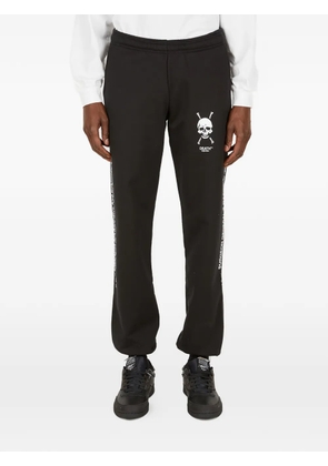 Death Cigarettes skull logo print trousers - Black