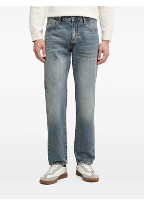 Armani Exchange logo-embroidered stonewashed jeans - Blue