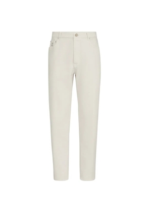 Brunello Cucinelli garment-dyed denim iconic fit five-pocket trousers with rips - White
