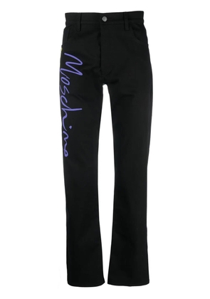 Moschino tailored logo-print trousers - Black