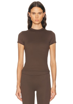 NikeSKIMS Matte Baby Short Sleeve Tee in Dark Sepia - Chocolate. Size S (also in XS, M, L, XL).