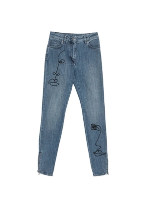 Moschino face-embroidery zip-cuff jeans - Blue