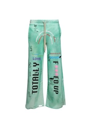 astrum distressed graphic-print track pants - Green