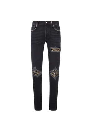 AMIRI stud-embellished distressed skinny jeans - Black