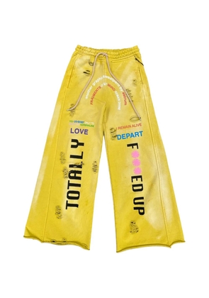 astrum distressed wide-leg track pants - Yellow