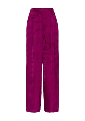 Balenciaga logo-pattern trousers - Purple