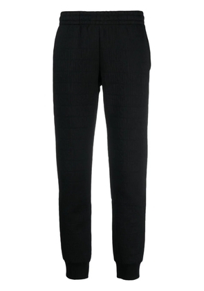 Moschino flocked-logo elasticated-waist track pants - Black