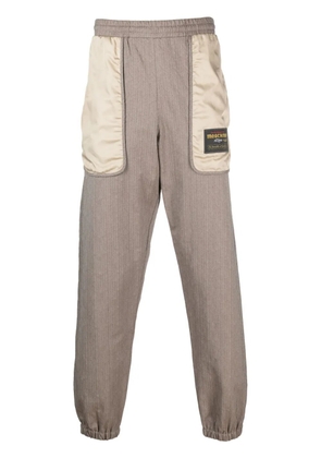 Moschino logo-patch panelled track pants - Brown