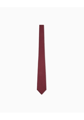 Silk tie with a small polka dot pattern