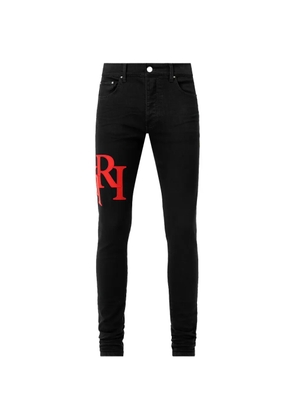 AMIRI staggered logo skinny jeans - Black
