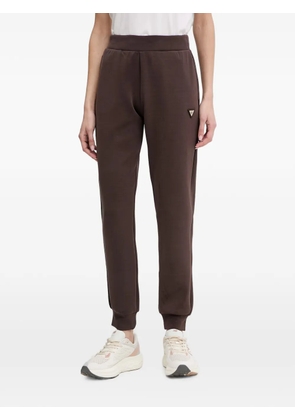 GUESS USA logo-plaque cuffed track pants - Brown