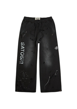 SATOSHI NAKAMOTO distressed paint-splatter track pants - Black