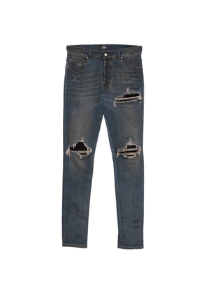 AMIRI Ultrasuede MX1 distressed slim-fit jeans - Blue